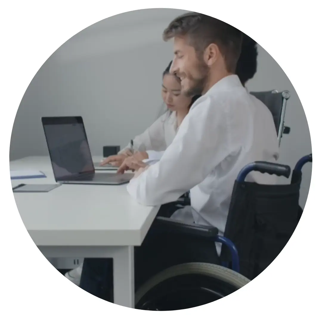 A man in a wheelchair working at a laptop