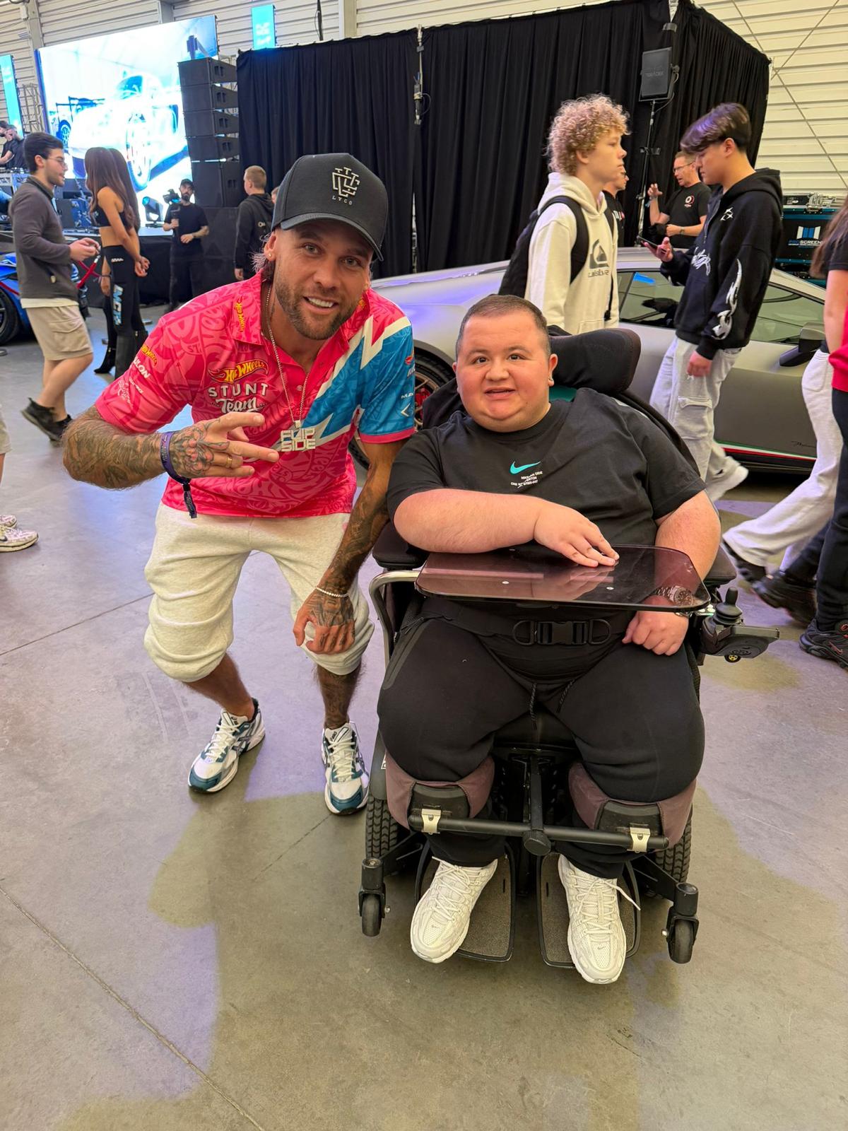 A Yours Truly participant meeting a member of a stunt team at a car show